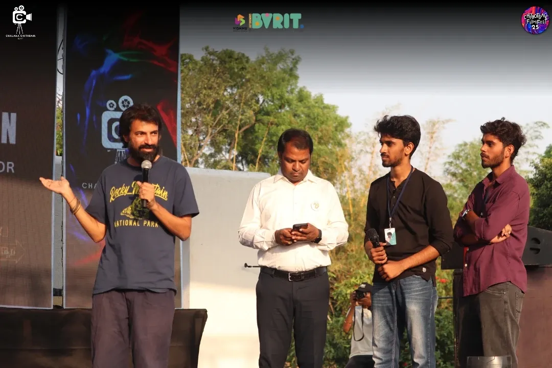 Nag Ashwin speaking on stage at Chitrostav 2K25, with Vikram and others beside him